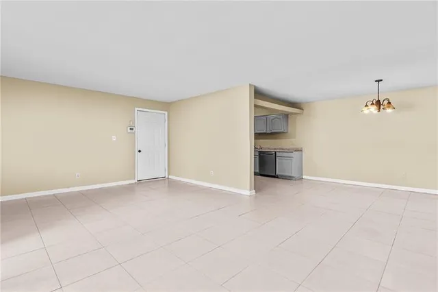 an empty room with a fireplace and cabinet