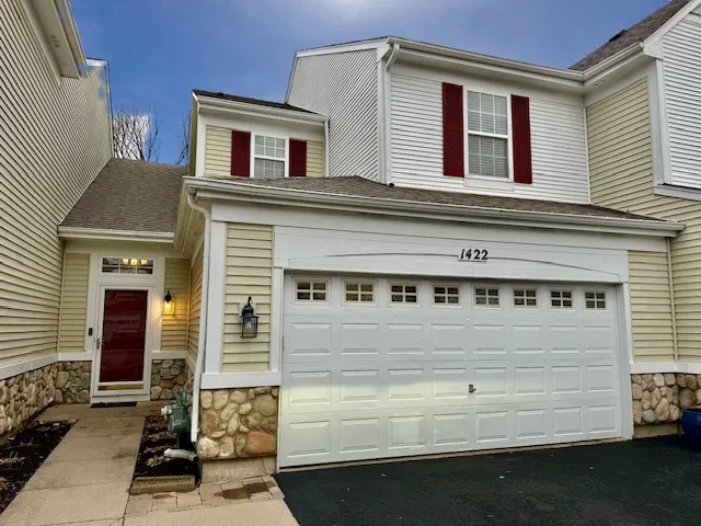 a front view of a house with a garage