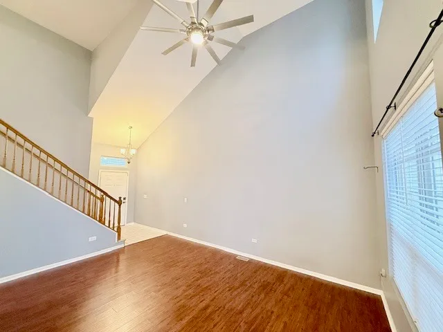 a view of a hallway with wooden floor and staircase