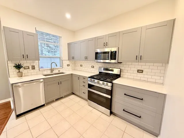 a kitchen with a sink stove and microwave