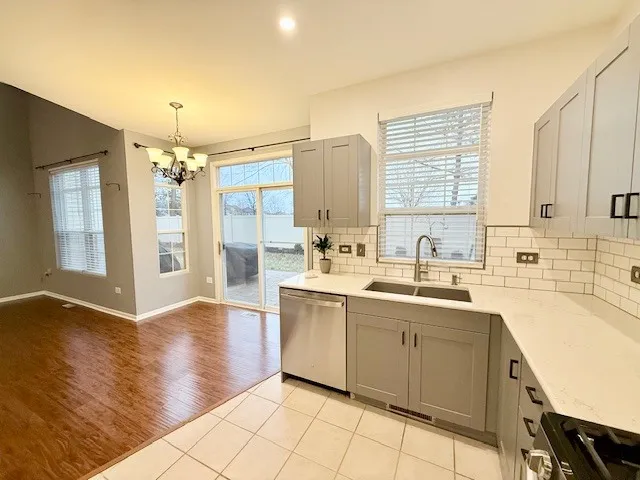 a large kitchen with a sink window and cabinets