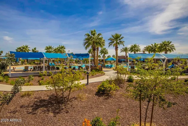 a front view of multi story residential apartment building with yard and green space