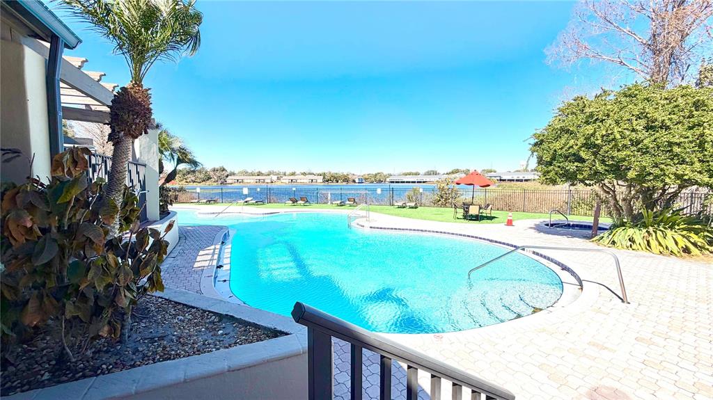 232 Afton Square, Unit 309 Altamonte Springs, FL 32714 - Photo 18 of 26 a view of a swimming pool with an outdoor seating and a yard