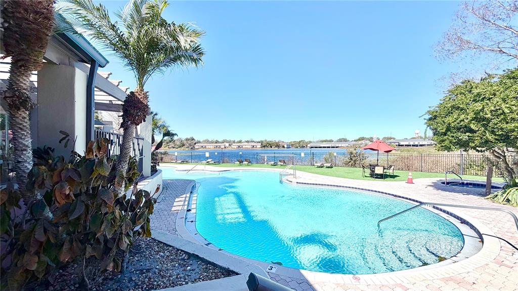 232 Afton Square, Unit 309 Altamonte Springs, FL 32714 - Photo 19 of 26 a view of a swimming pool with an outdoor seating and a yard