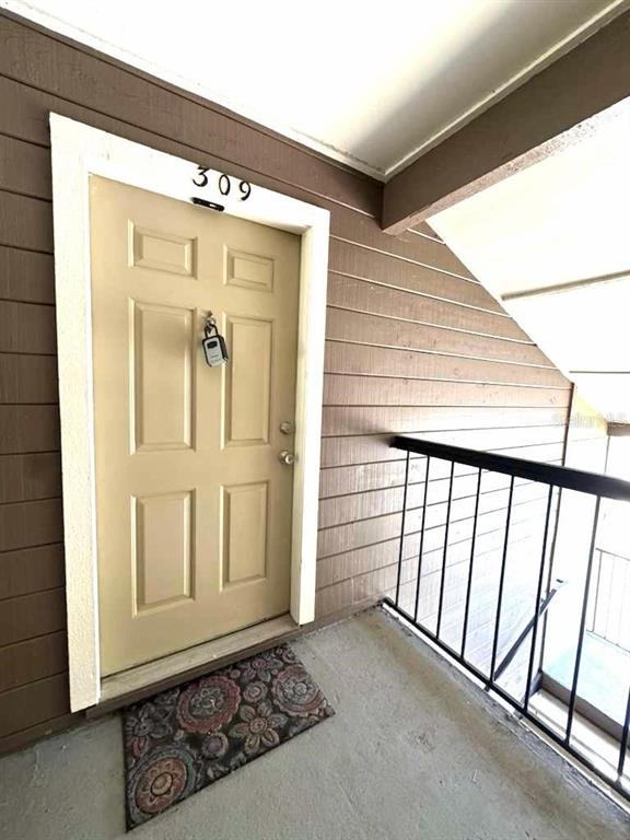 232 Afton Square, Unit 309 Altamonte Springs, FL 32714 - Photo 3 of 26 a view of a hallway with wooden floor and door