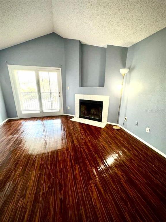 232 Afton Square, Unit 309 Altamonte Springs, FL 32714 - Photo 4 of 26 a view of empty room with wooden floor and fireplace