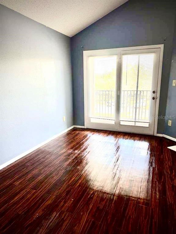 232 Afton Square, Unit 309 Altamonte Springs, FL 32714 - Photo 6 of 26 a view of an empty room with wooden floor and a window