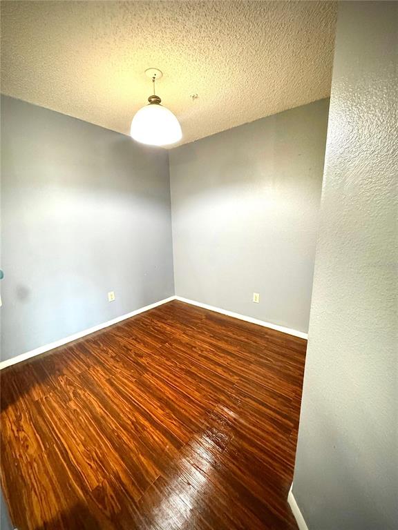 232 Afton Square, Unit 309 Altamonte Springs, FL 32714 - Photo 9 of 26 a view of a room with wooden floor and fan