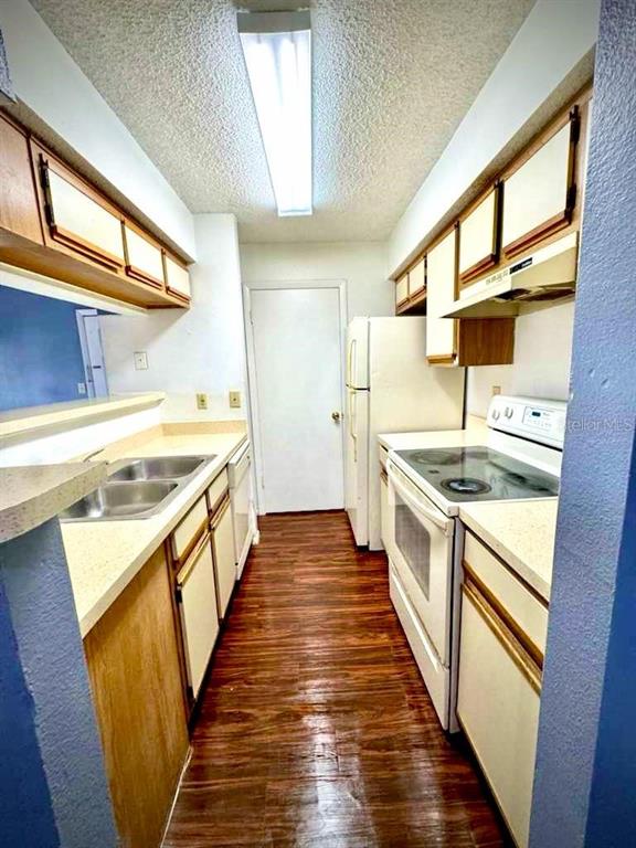 232 Afton Square, Unit 309 Altamonte Springs, FL 32714 - Photo 10 of 26 a kitchen with sink a stove and wooden floor