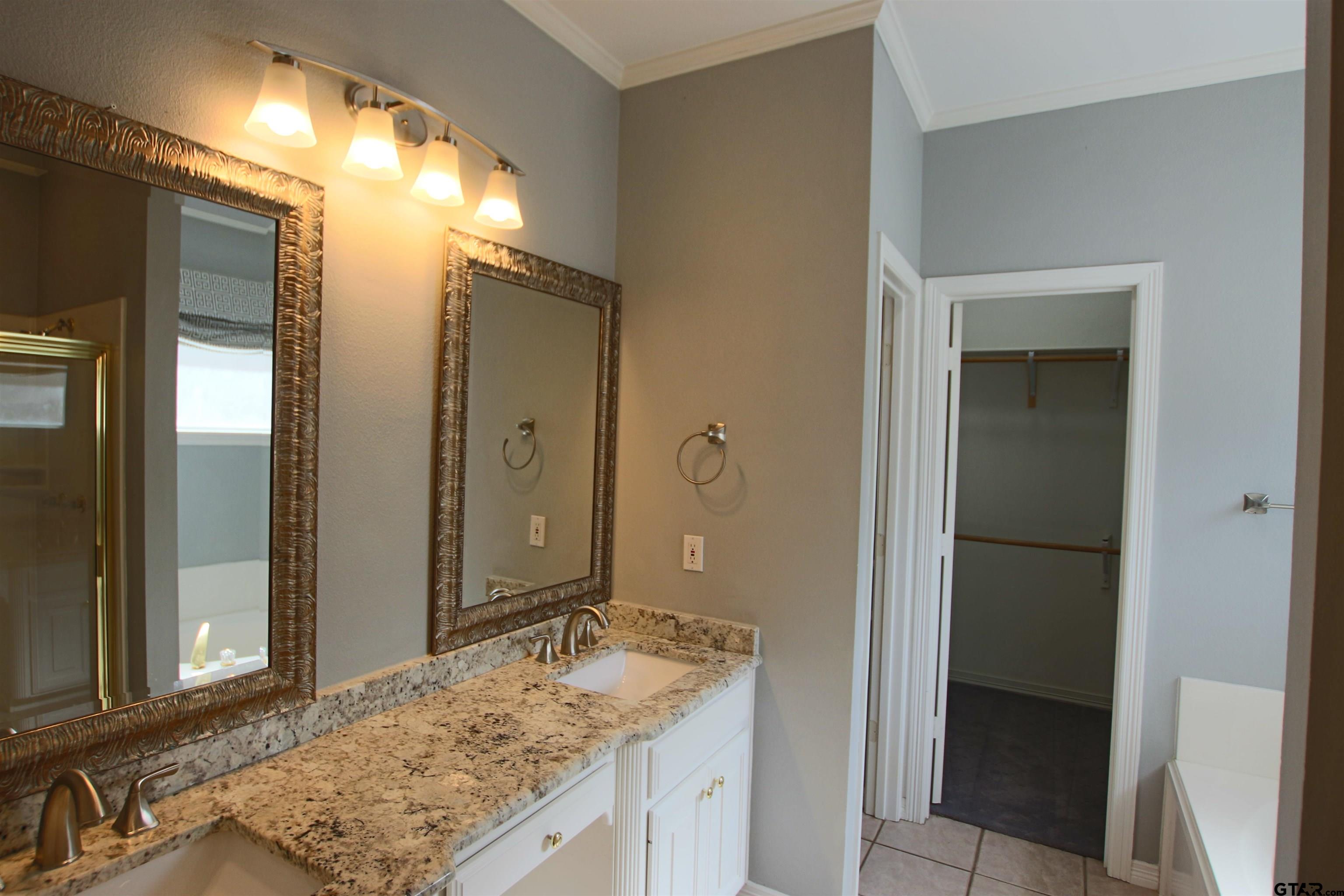 5707 Nicholson Drive Tyler, TX 75707 - Photo 14 of 23 a bathroom with a granite countertop sink and a mirror