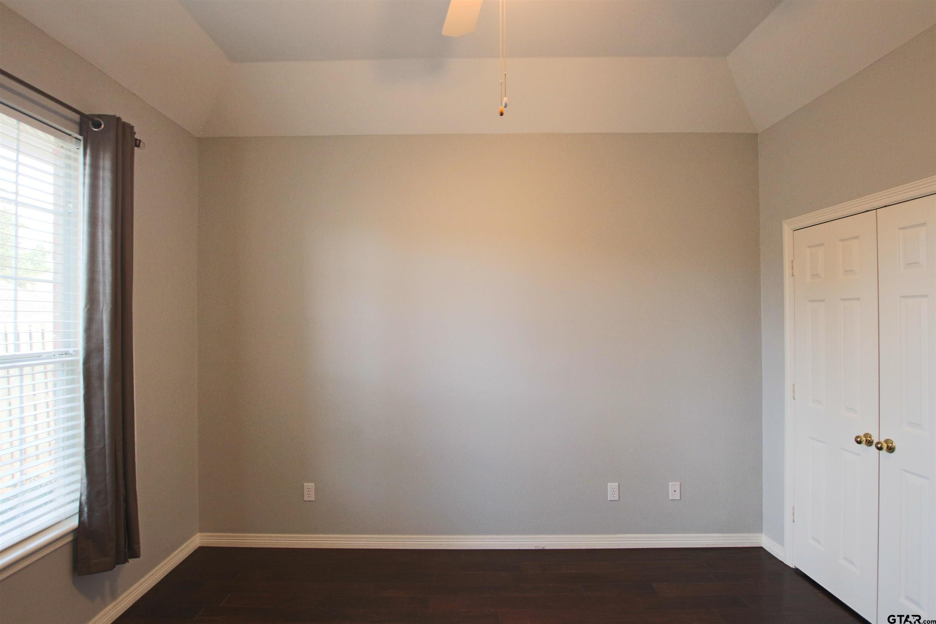 5707 Nicholson Drive Tyler, TX 75707 - Photo 17 of 23 an empty room with wooden floor and windows