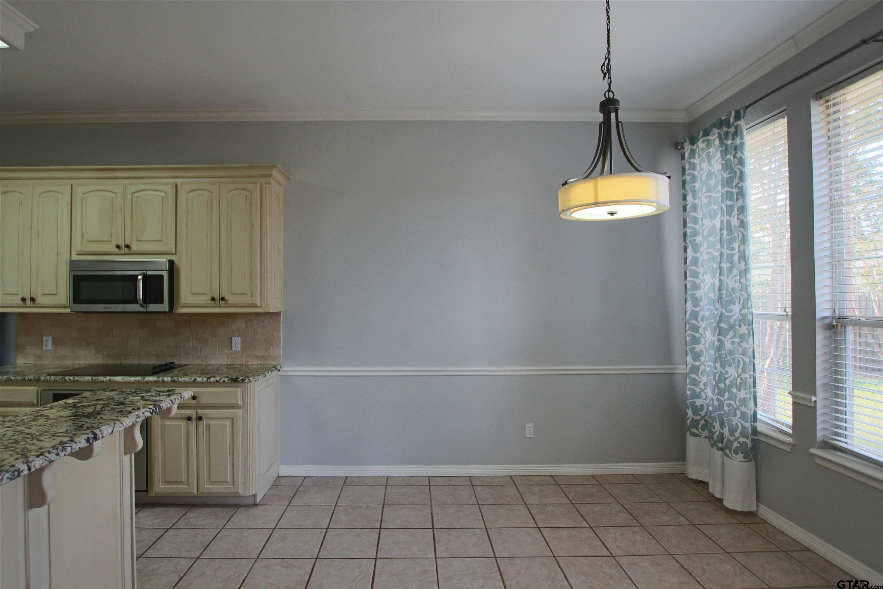 5707 Nicholson Drive Tyler, TX 75707 - Photo 6 of 23 a view of a kitchen with a sink and a window