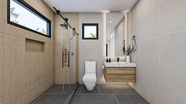 a bathroom with a toilet sink and shower