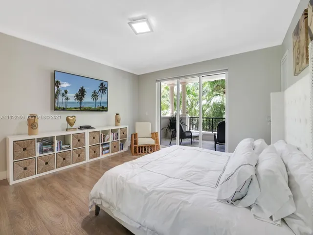 a bedroom with two beds and a large window