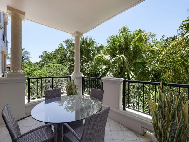 a view of a balcony with chair and wooden floor