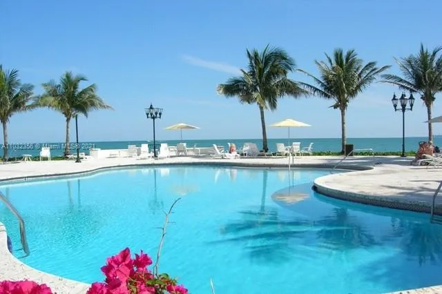 a view of house with yard outdoor seating and lake view