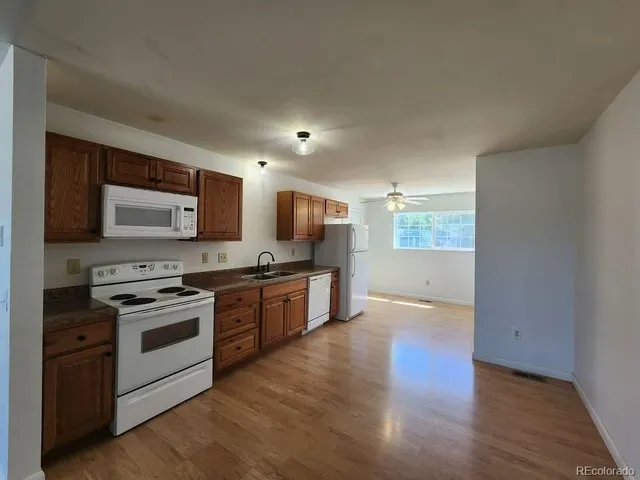 a kitchen with stainless steel appliances kitchen island granite countertop a stove a sink and a microwave