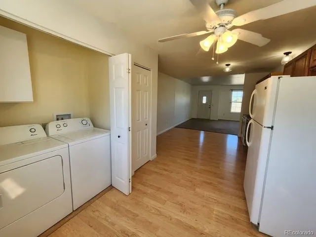 a view of a hallway with a kitchen