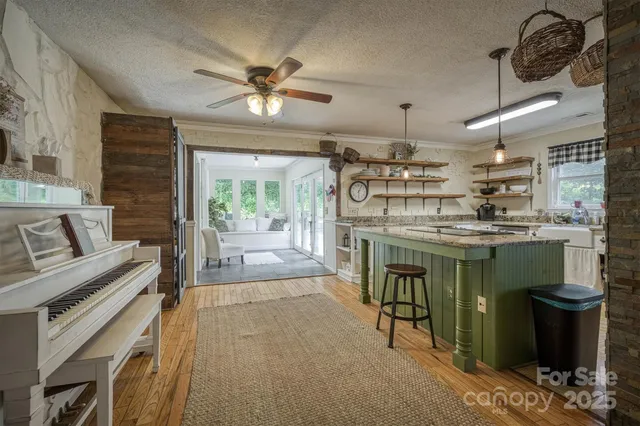 a kitchen with a stove a refrigerator and a fireplace