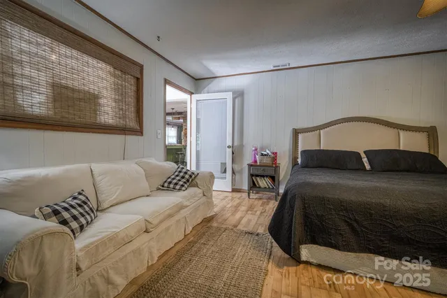 a bedroom with a bed couch and window