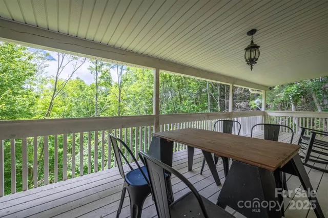 a view of a balcony with table and chairs