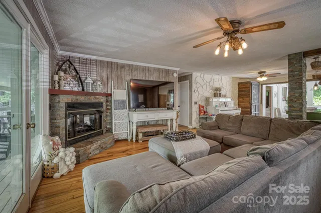 a living room with furniture a flat screen tv and a fireplace