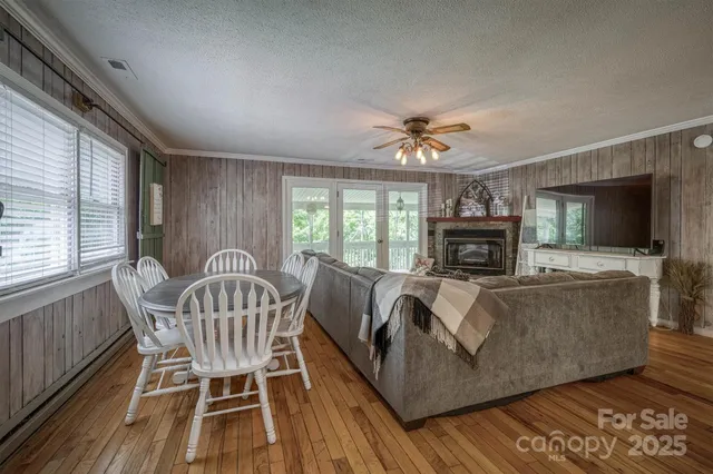 a living room with furniture a fireplace and a flat tv screen