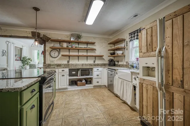 a kitchen with stainless steel appliances granite countertop a sink and cabinets