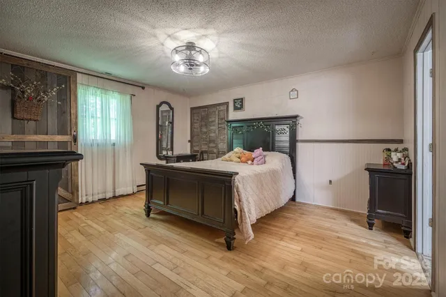 a bedroom with a bed and a chandelier