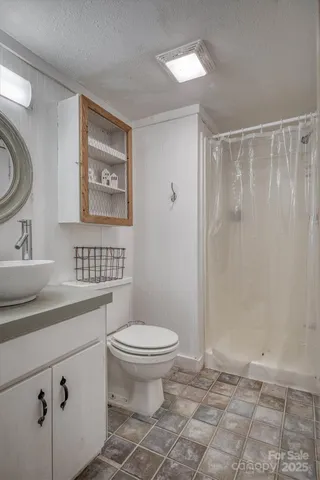 a view of a room that has a bed and wooden floor