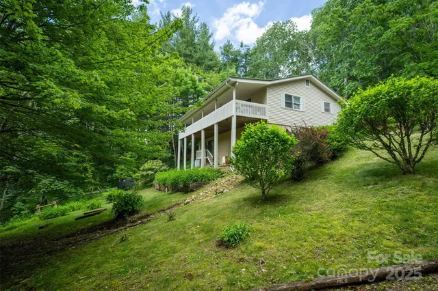 a view of a house with a yard and potted plants