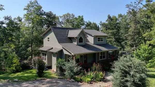 a kitchen with stainless steel appliances granite countertop a sink a stove and cabinets