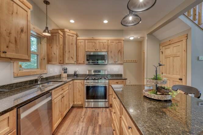 87 Harbin Court Morganton, GA 30560 - Photo 20 of 63 a kitchen with kitchen island granite countertop a sink cabinets and stainless steel appliances
