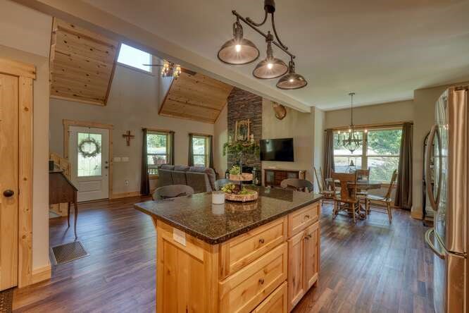 87 Harbin Court Morganton, GA 30560 - Photo 21 of 63 a view of a dining room and livingroom with furniture wooden floor a chandelier