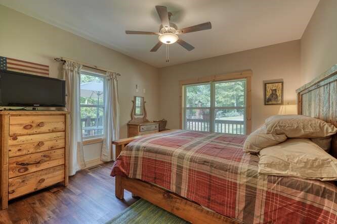 87 Harbin Court Morganton, GA 30560 - Photo 23 of 63 a bedroom with a bed and a flat tv screen on dresser
