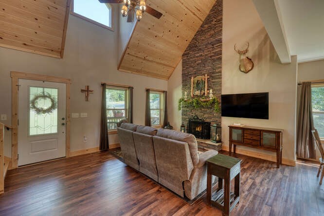 87 Harbin Court Morganton, GA 30560 - Photo 3 of 63 a living room with furniture a flat screen tv and a fireplace