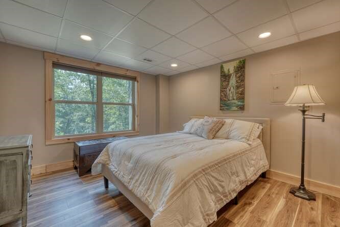 87 Harbin Court Morganton, GA 30560 - Photo 36 of 63 a bedroom with a large bed and a wooden floor