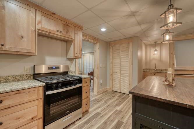87 Harbin Court Morganton, GA 30560 - Photo 5 of 63 a kitchen with stainless steel appliances granite countertop a sink stove and cabinets