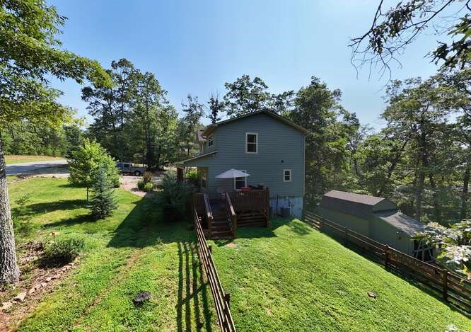 87 Harbin Court Morganton, GA 30560 - Photo 51 of 63 a backyard of a house with a garden and plants