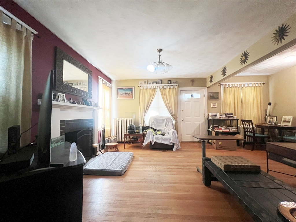 169 Grovers Avenue Winthrop, MA 02152 - Photo 12 of 31 a living room with furniture fireplace and a large window