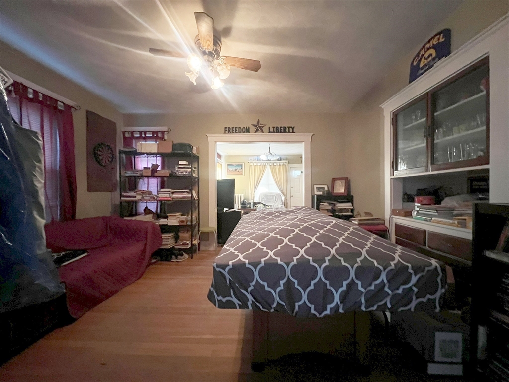 169 Grovers Avenue Winthrop, MA 02152 - Photo 14 of 31 a bed sitting in a bedroom next to a window with bookshelf