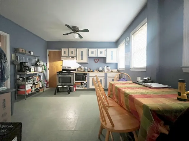 a kitchen with a table chairs a sink and cabinets