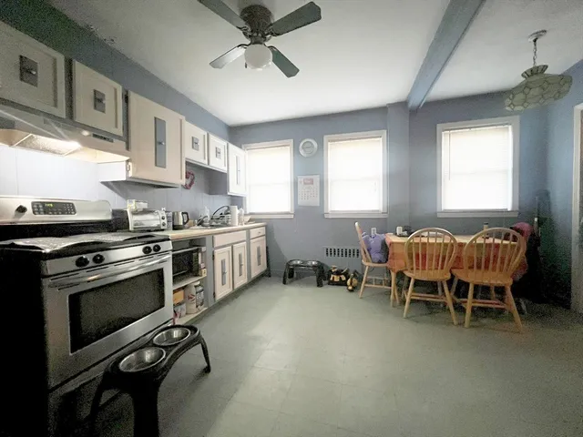 a kitchen with stainless steel appliances kitchen island granite countertop a stove a sink and a refrigerator
