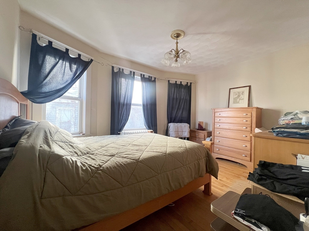 169 Grovers Avenue Winthrop, MA 02152 - Photo 17 of 31 a bedroom with a bed and a mirror