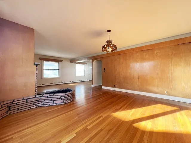 a view of a room with wooden floor and fan