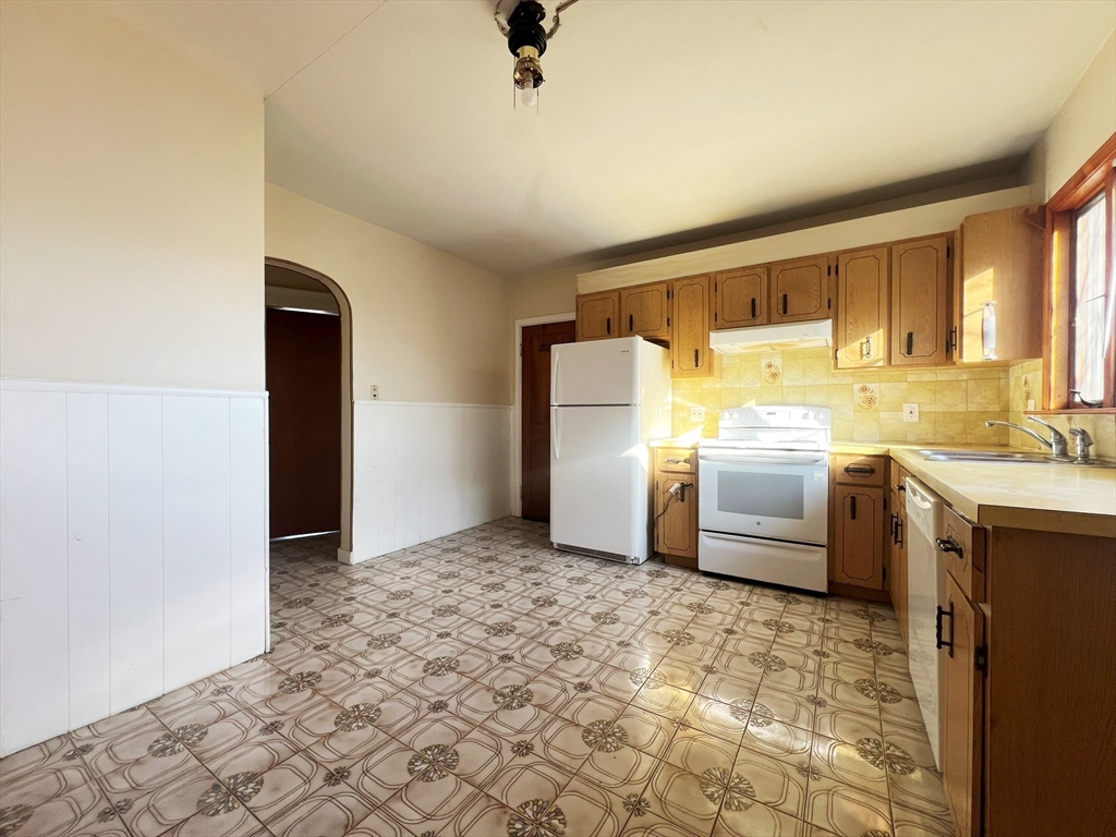 169 Grovers Avenue Winthrop, MA 02152 - Photo 22 of 31 a kitchen with a refrigerator sink and cabinets