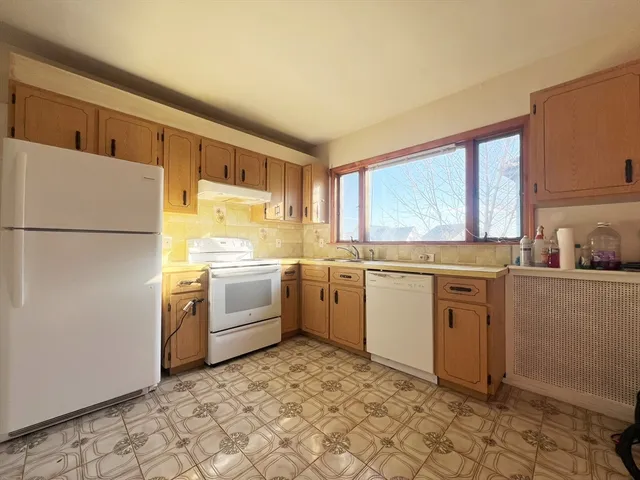 a kitchen with a stove top oven sink and cabinets