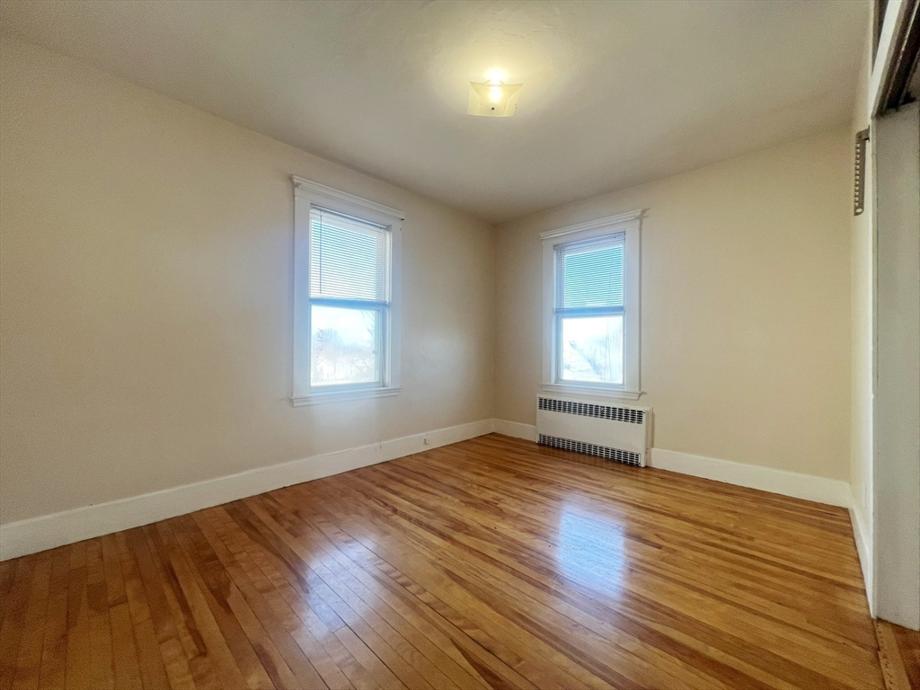 169 Grovers Avenue Winthrop, MA 02152 - Photo 24 of 31 an empty room with wooden floor and windows