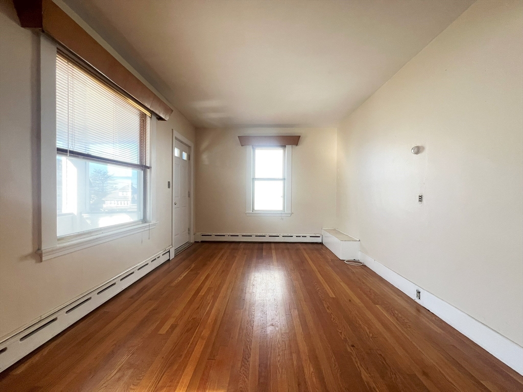 169 Grovers Avenue Winthrop, MA 02152 - Photo 26 of 31 an empty room with wooden floor and windows