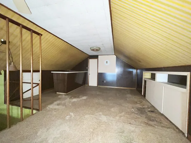 a picture of a bench in front of a wall